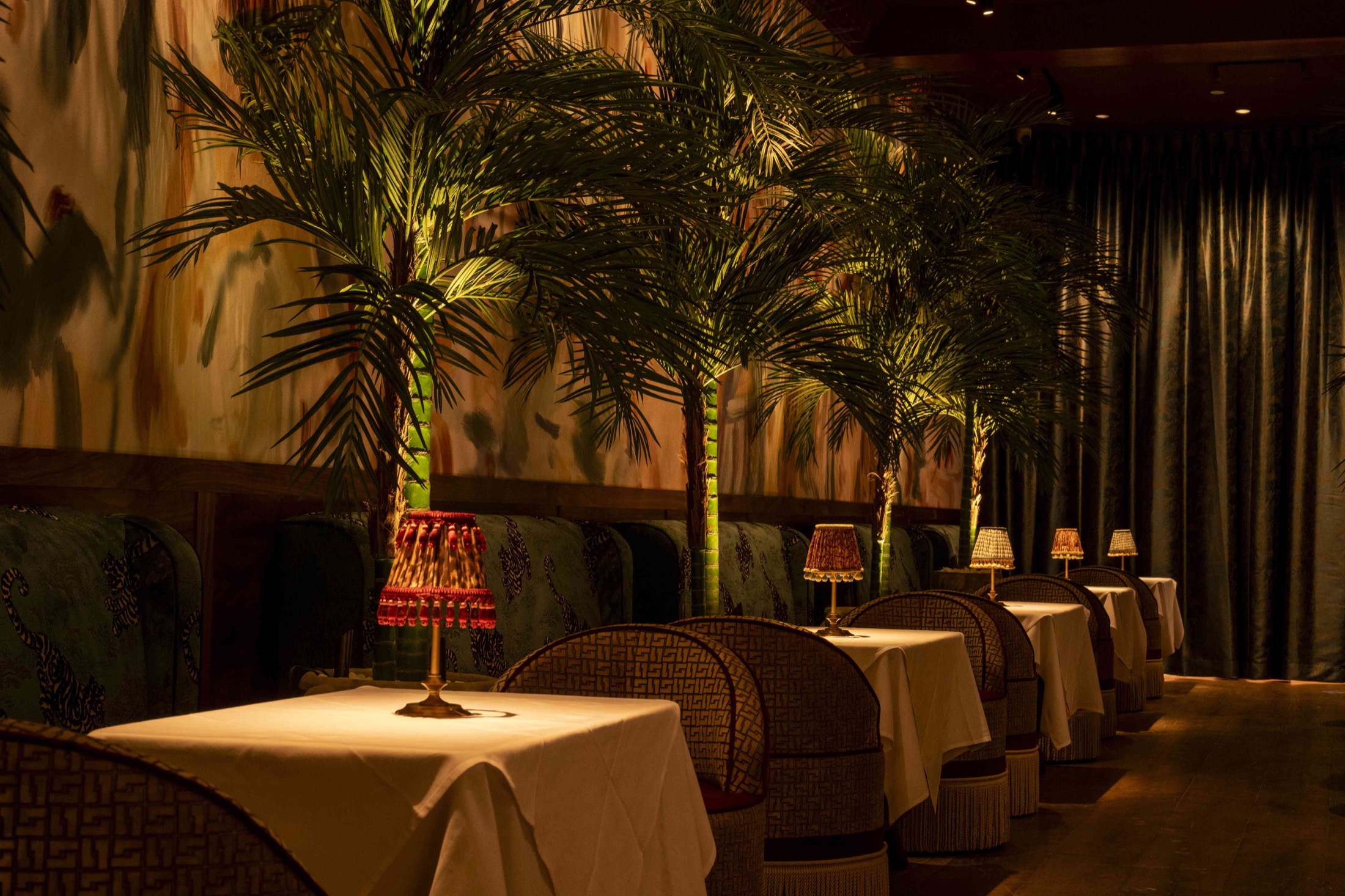 The palm-lined dining room at Le Bar Penelope on the Upper East Side